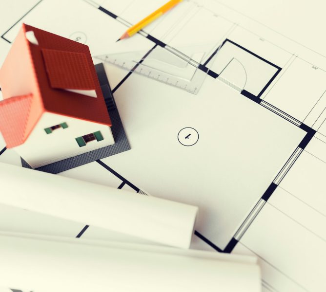 close up of house model on architectural blueprint