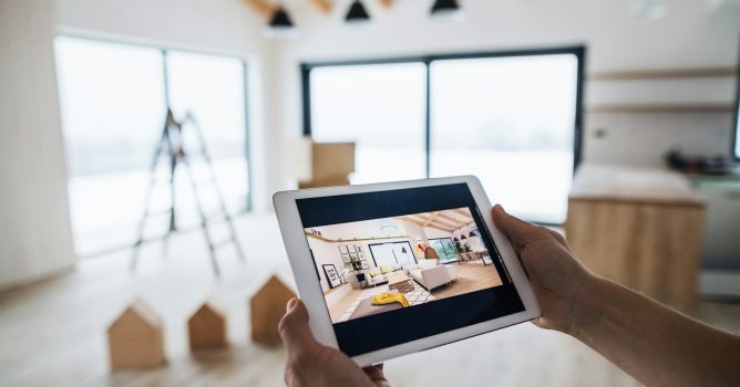 Midsection of man with tablet, looking at interior design sketches. A new home concept.